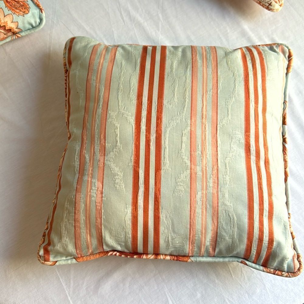 Orange and blue decorator pillow, 15 x 15”